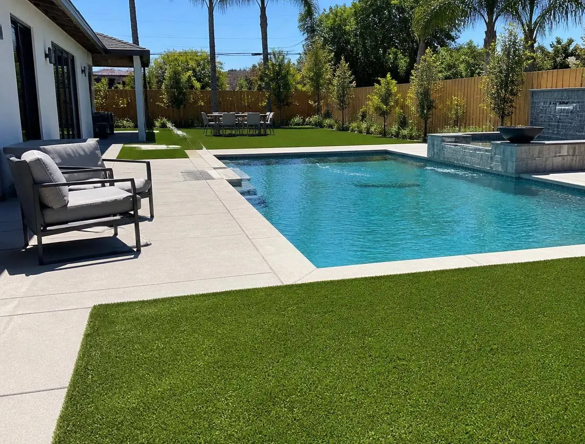 Artificial turf installed around a backyard swimming pool deck in Riverside CA
